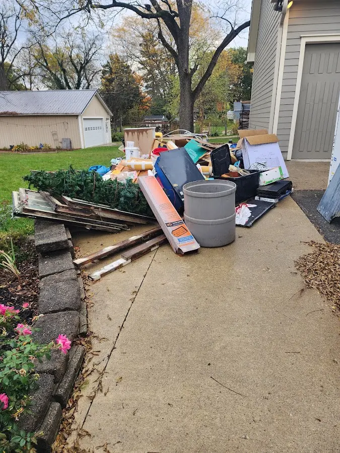 Dumpster being loaded with debris for 3 Yard Dumpster Rental in Elmwood